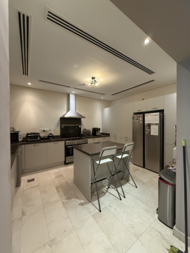 Modern kitchen cabinets with a vinyl wrap finish in Dubai