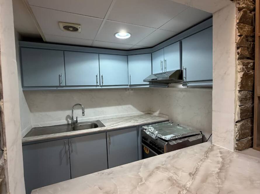 Blue kitchen cupboards with vinyl wrapping in Dubai