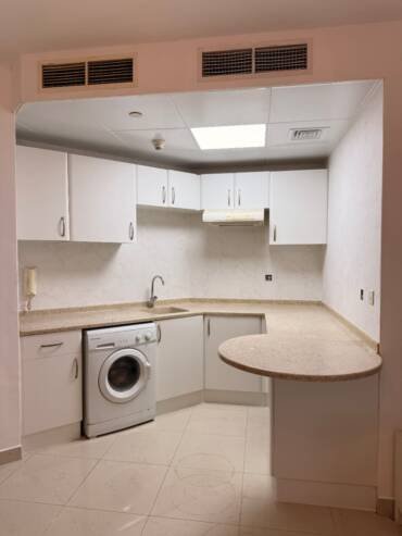 White kitchen cabinets with a modern vinyl wrap finish in Dubai