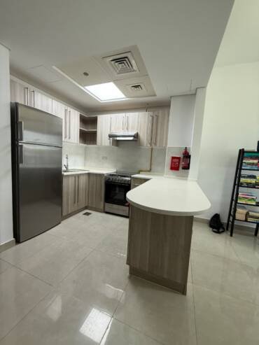 Modern kitchen refurbishment with updated cabinets and island unit in Dubai